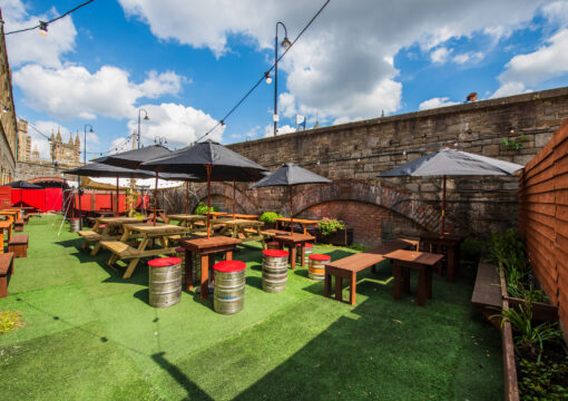 outdoor benches underneath an umbrella