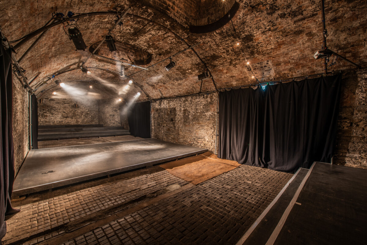 Empty Loco Klub tunnel 5, a theatre stage is in the middle.