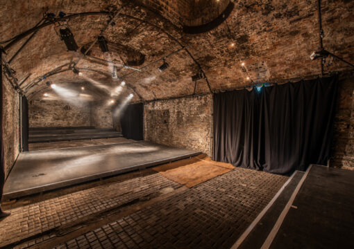 Empty Loco Klub tunnel 5, a theatre stage is in the middle.