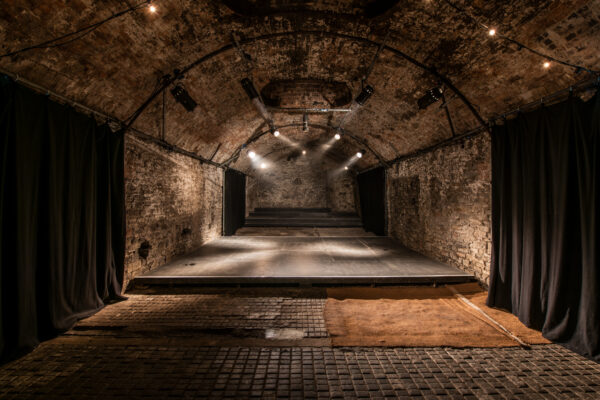 Tunnel 5 lit by white light with a platform in the middle.