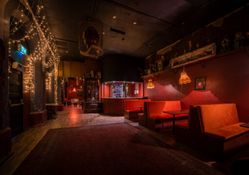 a seating area with seats facing each other lit by a red light