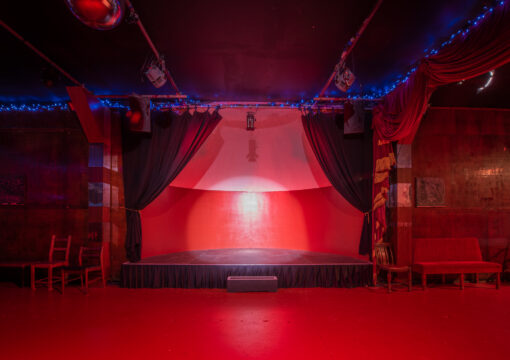 the stage inthe social club. a spotlight is lighting the stage.