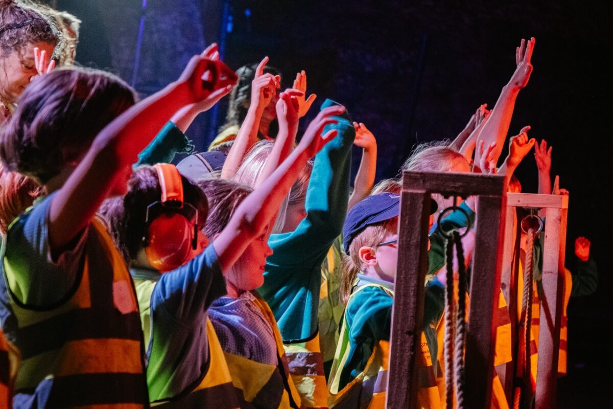 children putting their hands in the air