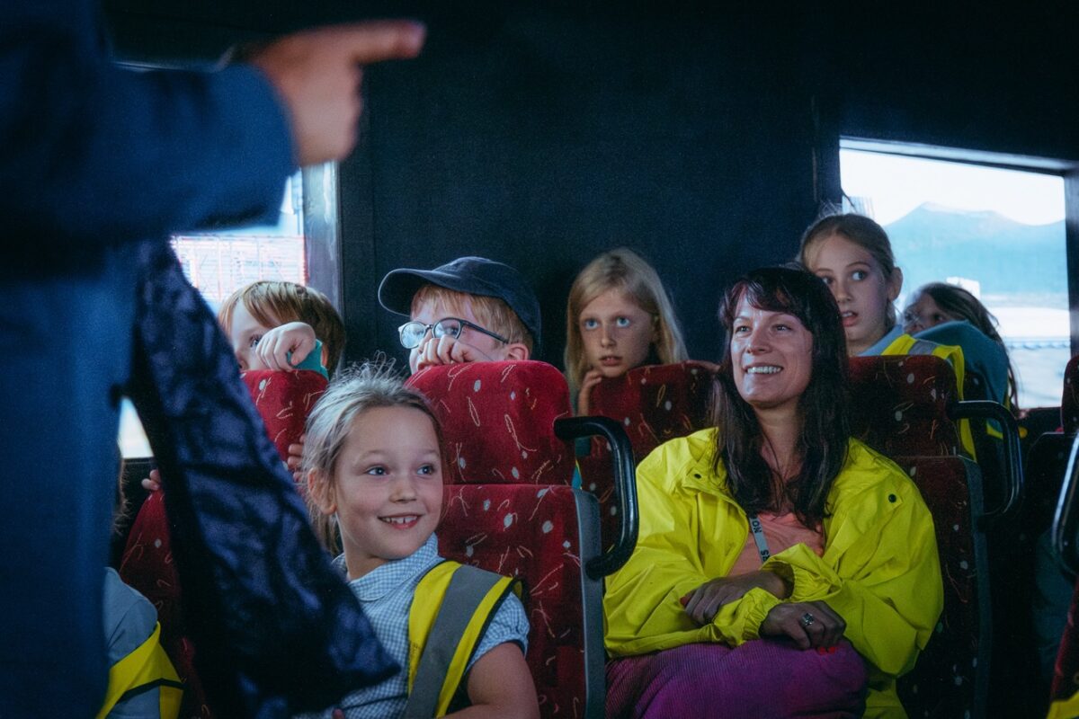 children and adults smiling at the camera