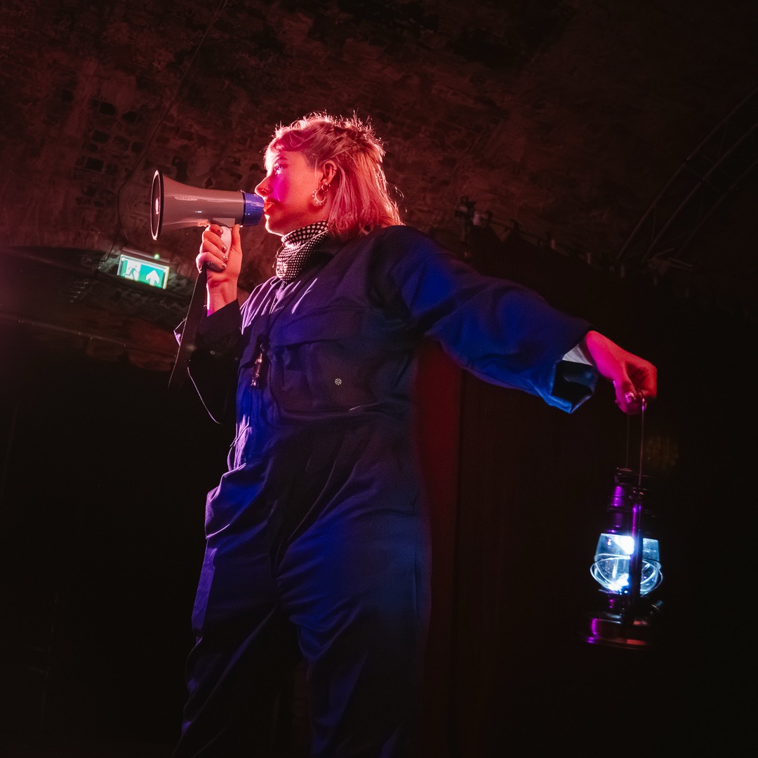 A performer talking into a megaphone. 