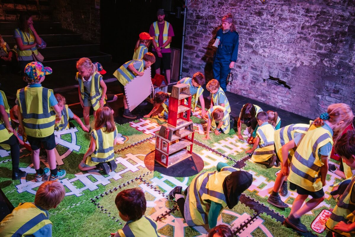 Children playing on train track themed set. 
