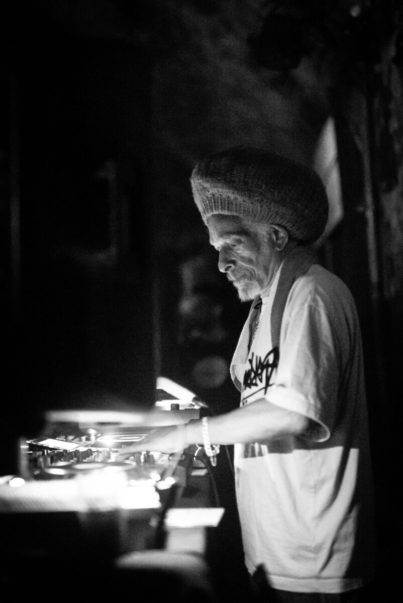 An image of Don Letts DJing at Loco Klub for the Diaspora event. The image is greyscale.